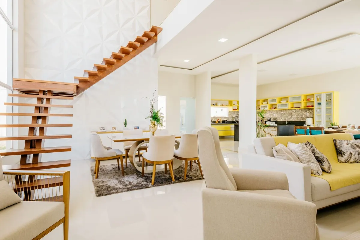 A spacious modern living room with elegant furniture and an open kitchen, showcasing effective space utilization.