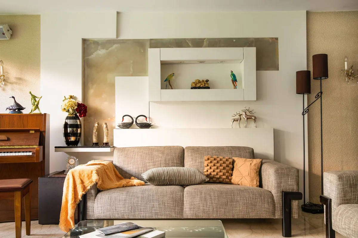 A cozy living room with a stylish sofa, decorative items, and a piano, highlighting effective clutter organization.